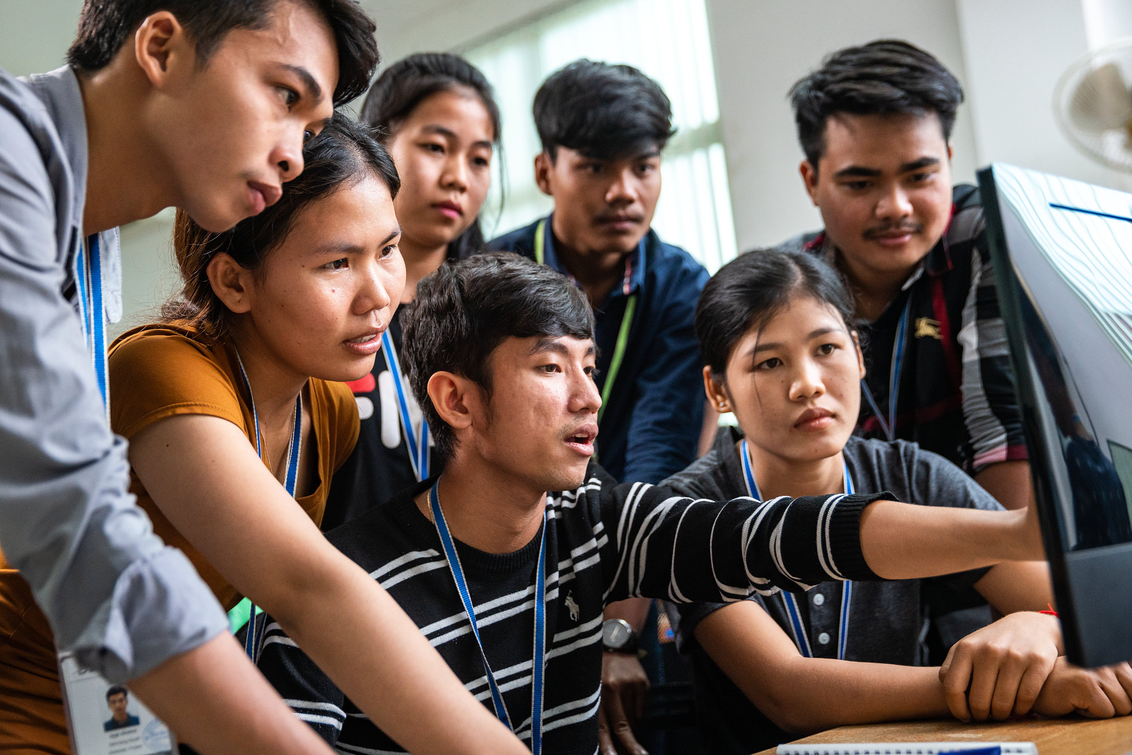 DDD documentary staff checking a document on-screen in Phnom Penh, Cambodia