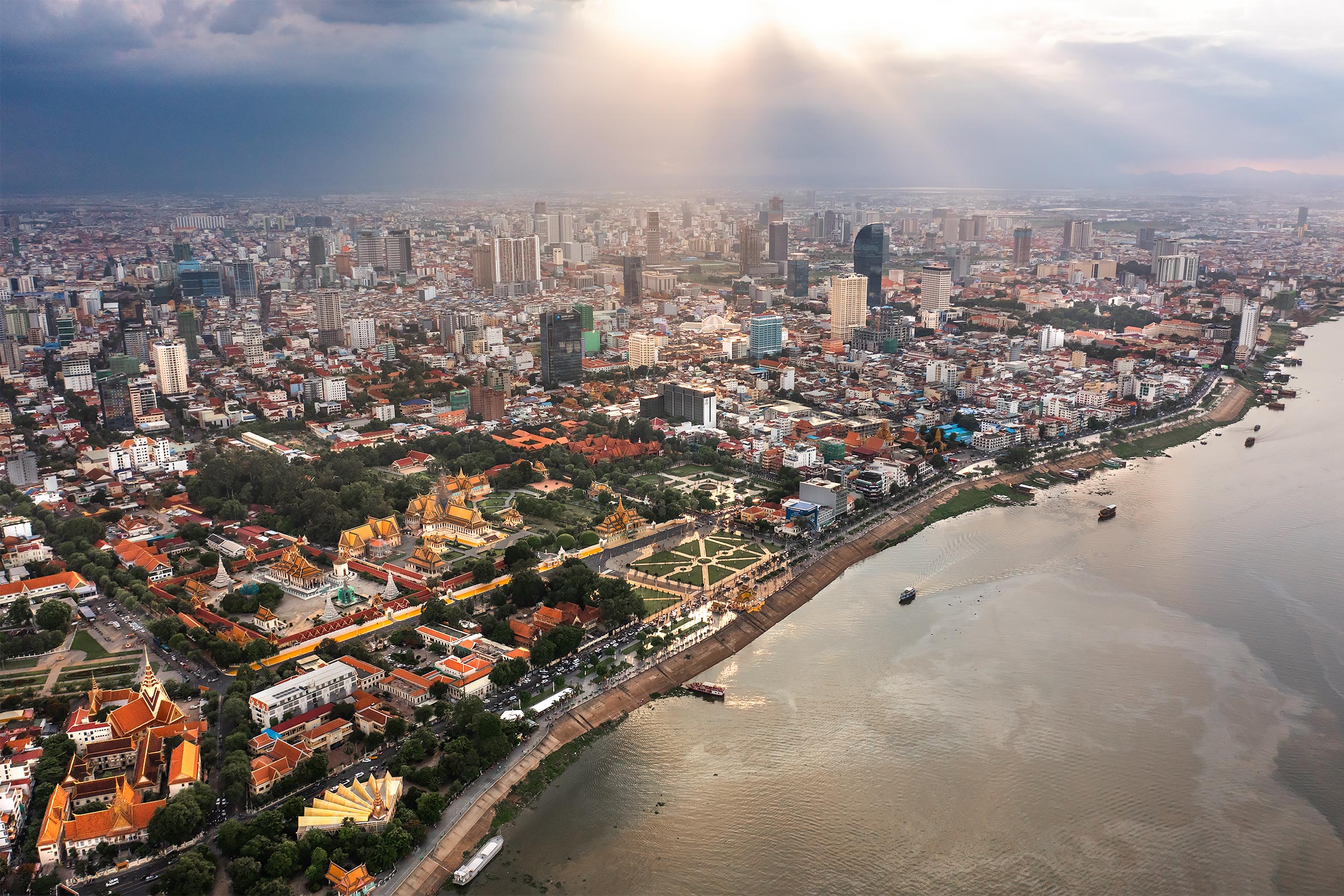 Aerial view of the Phnom Penh skyline and the Royal Palace with sun | Drone Photographer in Cambodia